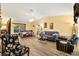 Living room with gray couch and laminate wood floor at 860 Evelynton Loop, The Villages, FL 32162