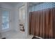 Cozy bathroom featuring a toilet and bathtub/shower combo with white walls and tiled floors at 963 Hart Dr, The Villages, FL 32163