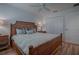 King-size bedroom with ceiling fan and double doors at 963 Hart Dr, The Villages, FL 32163