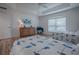 Bright bedroom featuring tray ceilings, natural light, and wood-look flooring at 963 Hart Dr, The Villages, FL 32163