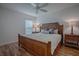 Bedroom with a wood bed frame, wood-look floors, and a ceiling fan at 963 Hart Dr, The Villages, FL 32163