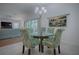 Charming dining area with glass-top table and patterned chairs at 963 Hart Dr, The Villages, FL 32163