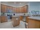 Spacious kitchen featuring an island, stainless steel appliances, and wood cabinets at 963 Hart Dr, The Villages, FL 32163