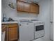 Laundry room with washer, dryer, and additional storage cabinets at 963 Hart Dr, The Villages, FL 32163