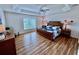 Spacious main bedroom with a tray ceiling, a ceiling fan, and wood-look floors at 963 Hart Dr, The Villages, FL 32163