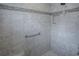 Walk-in shower featuring tile surround, accent tile, and a handheld shower head at 963 Hart Dr, The Villages, FL 32163