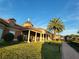 Trilogy community clubhouse, columns and palm trees at 97 Bayou Bend Rd, Groveland, FL 34736