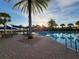 Relaxing pool area with lounge chairs and palm trees at 97 Bayou Bend Rd, Groveland, FL 34736