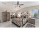 Bedroom with wood floors, ceiling fan, and neutral decor at 1007 Dustin Dr, The Villages, FL 32159