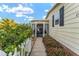 Inviting front entry with a white picket fence and walkway at 1007 Dustin Dr, The Villages, FL 32159