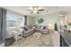 Bright living room with a cozy sectional sofa and decorative rug at 1007 Dustin Dr, The Villages, FL 32159