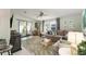 Comfortable living room with L-shaped sofa and access to patio at 1007 Dustin Dr, The Villages, FL 32159
