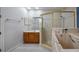 Bathroom with walk-in shower and large bathtub at 102 Camino Real Blvd # 102, Howey In The Hills, FL 34737
