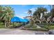 Inviting entrance to the Mission Inn Resort & Club featuring a covered walkway, lovely landscaping, and classic architecture at 102 Camino Real Blvd # 102, Howey In The Hills, FL 34737