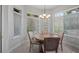 Bright dining area features a round table, four chairs, and abundant natural light at 102 Camino Real Blvd # 102, Howey In The Hills, FL 34737