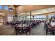 Elegant dining room with ample seating, large windows offering lake views, chandeliers and full bar at Mission Inn at 102 Camino Real Blvd # 102, Howey In The Hills, FL 34737