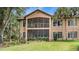 Two-story home with screened porch and lush landscaping at 102 Camino Real Blvd # 102, Howey In The Hills, FL 34737