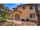 Back exterior view of the townhome showcasing patio and landscaping at 102 Camino Real Blvd # 102, Howey In The Hills, FL 34737
