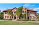 Grand two-story home with tile roof and lush landscaping at 102 Camino Real Blvd # 102, Howey In The Hills, FL 34737
