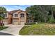 Two-story townhome with two-car garage and lush landscaping at 102 Camino Real Blvd # 102, Howey In The Hills, FL 34737