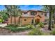 Charming exterior showcasing lush landscaping and a private entrance to the delightful terracotta roofed home at 102 Camino Real Blvd # 102, Howey In The Hills, FL 34737