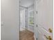 Clean hallway with light wood flooring and doors at 102 Camino Real Blvd # 102, Howey In The Hills, FL 34737