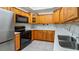 Well-equipped kitchen featuring wood cabinets and stainless steel appliances at 102 Camino Real Blvd # 102, Howey In The Hills, FL 34737