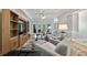 Spacious living area with hardwood floors and built-in shelving at 102 Camino Real Blvd # 102, Howey In The Hills, FL 34737