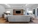 Bright living room features hardwood floors, comfy seating, and built-in shelving at 102 Camino Real Blvd # 102, Howey In The Hills, FL 34737