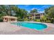 Community pool with adjacent patio and building at 102 Camino Real Blvd # 102, Howey In The Hills, FL 34737