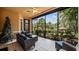 Relaxing screened porch with seating area overlooking lush landscape at 102 Camino Real Blvd # 102, Howey In The Hills, FL 34737
