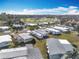 Aerial view of a 55+ community with homes, landscaping, and a baseball field at 1026 Capella Dr, Tavares, FL 32778
