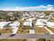 Aerial view of 55+ community with many homes and a golf cart at 1026 Capella Dr, Tavares, FL 32778