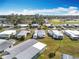 Aerial view of a 55+ community showcasing various homes and a baseball field in the distance at 1026 Capella Dr, Tavares, FL 32778