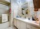 Clean bathroom with vanity, shower, and floral wallpaper at 1026 Capella Dr, Tavares, FL 32778
