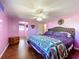 Large bedroom with king-size bed, ceiling fan, and hardwood floors at 1026 Capella Dr, Tavares, FL 32778