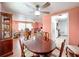 Charming dining room with wood table and access to living area at 1026 Capella Dr, Tavares, FL 32778