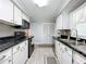 Modern kitchen with black appliances and white cabinets at 1026 Capella Dr, Tavares, FL 32778