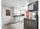 Galley kitchen with white cabinets and modern appliances at 1026 Capella Dr, Tavares, FL 32778