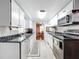 Efficient kitchen featuring white cabinets and black countertops at 1026 Capella Dr, Tavares, FL 32778