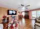 Large living room with hardwood floors, TV, and dining area view at 1026 Capella Dr, Tavares, FL 32778