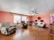 Spacious living room with comfy seating and wood floors at 1026 Capella Dr, Tavares, FL 32778