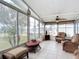 Bright sunroom with wicker furniture and tiled floors at 1026 Capella Dr, Tavares, FL 32778
