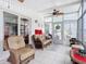 Comfortable sunroom with wicker furniture and tiled floors at 1026 Capella Dr, Tavares, FL 32778