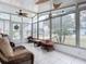 Sunroom with wicker furniture and a view of the yard at 1026 Capella Dr, Tavares, FL 32778