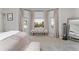 Sunlit bedroom featuring a bay window and a neutral color palette at 12037 Ne 51St Cir, Oxford, FL 34484