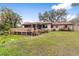 Home with deck and landscaped backyard at 1208 Gibson St, Leesburg, FL 34748