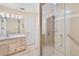 Well-lit bathroom with glass enclosed shower, vanity, and ample counter space at 1208 Gibson St, Leesburg, FL 34748