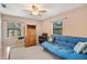 Bedroom with a blue futon, ceiling fan, and window at 1208 Gibson St, Leesburg, FL 34748