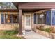 Front entrance with brick facade and blue shutters at 1208 Gibson St, Leesburg, FL 34748